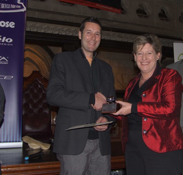 Nathaniel Benefield receiving award from the Hon. Lianne Dalziel